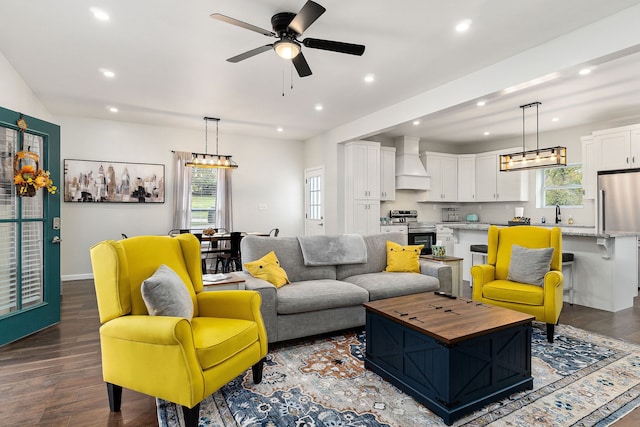 living room featuring hardwood / wood-style flooring, a healthy amount of sunlight, and ceiling fan