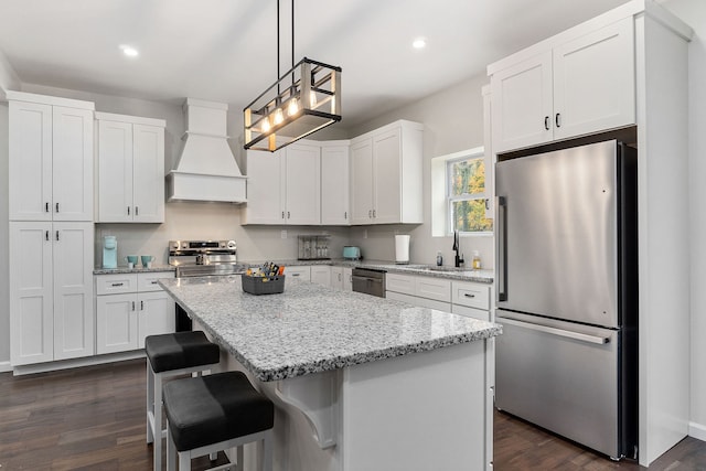 kitchen with premium range hood, white cabinetry, a center island, and stainless steel appliances