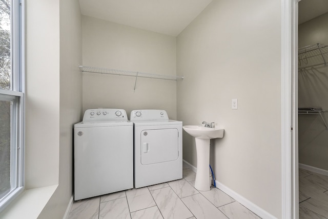 washroom with washer and dryer and sink