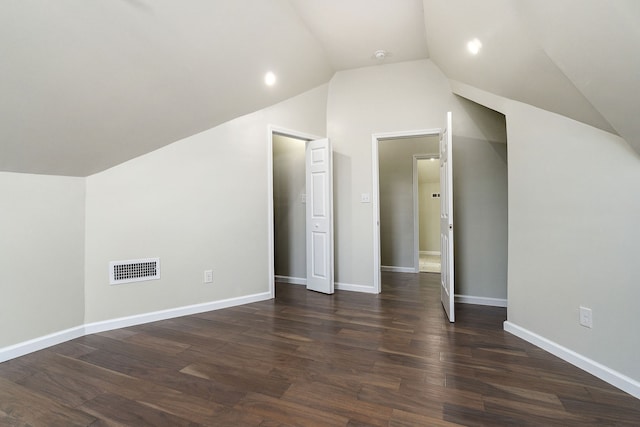 bonus room featuring dark hardwood / wood-style floors and vaulted ceiling