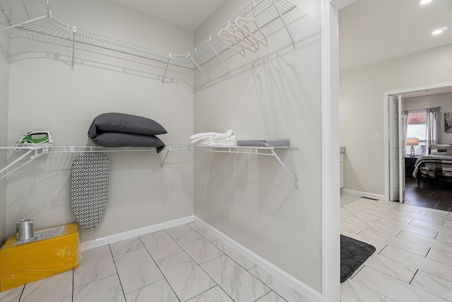 walk in closet featuring light hardwood / wood-style flooring