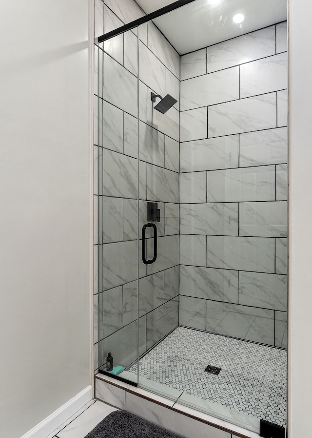 bathroom featuring a shower with shower door