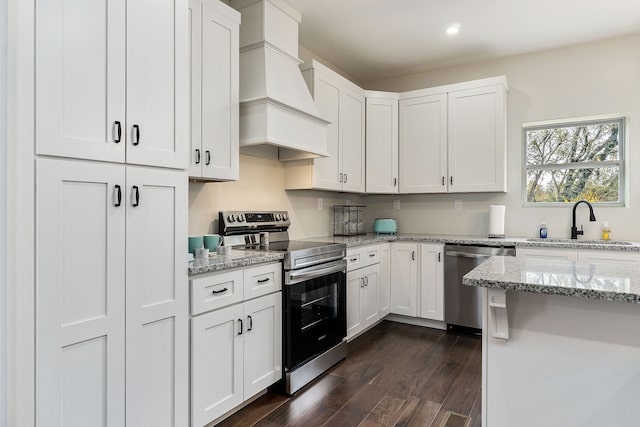 kitchen featuring custom exhaust hood, dark hardwood / wood-style floors, white cabinets, and stainless steel appliances