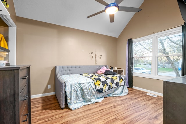 bedroom featuring ceiling fan, light hardwood / wood-style flooring, and lofted ceiling