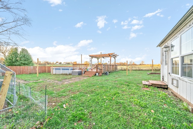 view of yard featuring a pool side deck and a pergola