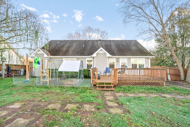 rear view of house with an outdoor structure and a deck