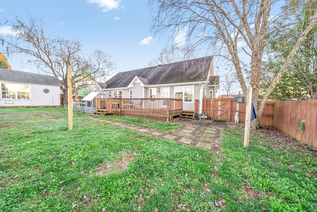 back of house with a wooden deck and a lawn