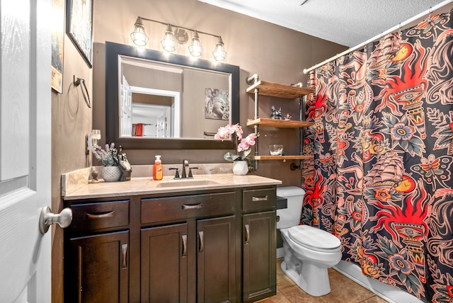 bathroom featuring toilet, vanity, a textured ceiling, and tile patterned floors