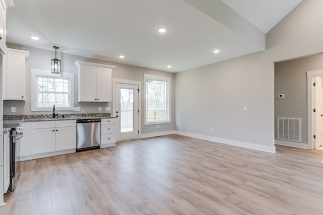 kitchen featuring white cabinets, appliances with stainless steel finishes, light wood-type flooring, and sink