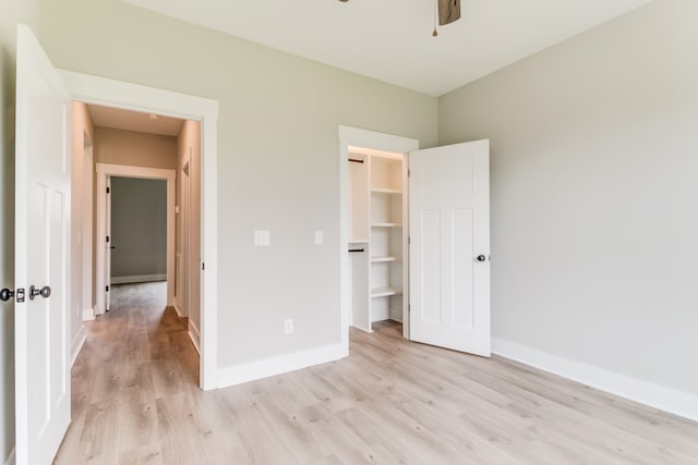 unfurnished bedroom featuring light hardwood / wood-style floors and a closet