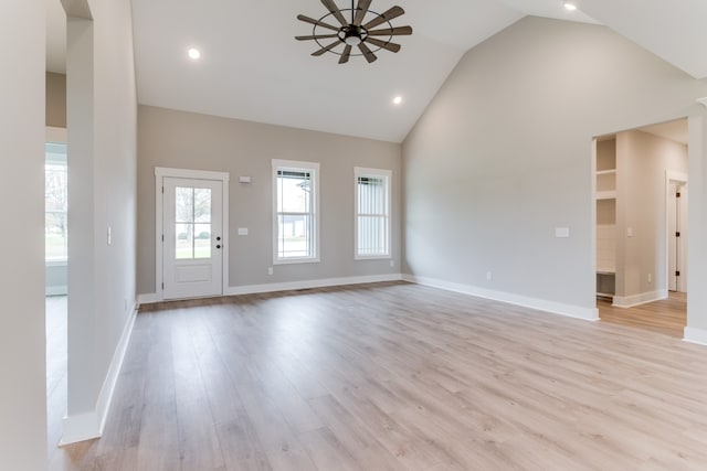 unfurnished living room featuring light hardwood / wood-style floors, high vaulted ceiling, and ceiling fan