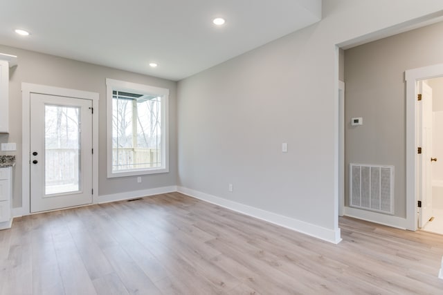 unfurnished room with light wood-type flooring