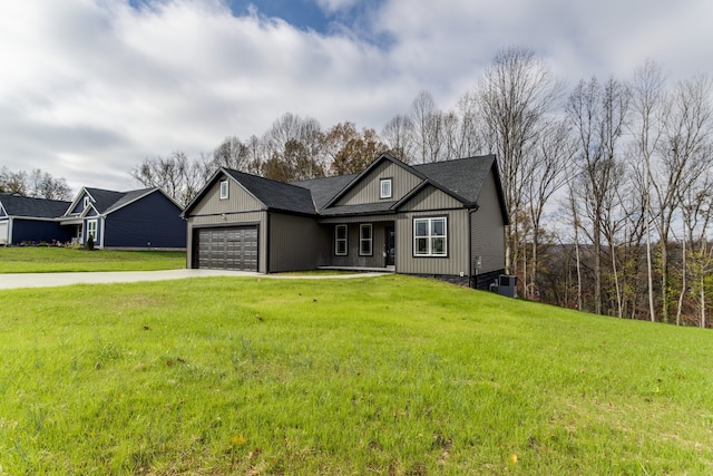 view of front of house with a garage and a front lawn