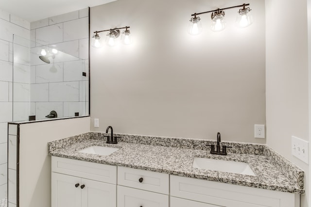 bathroom featuring vanity and tiled shower