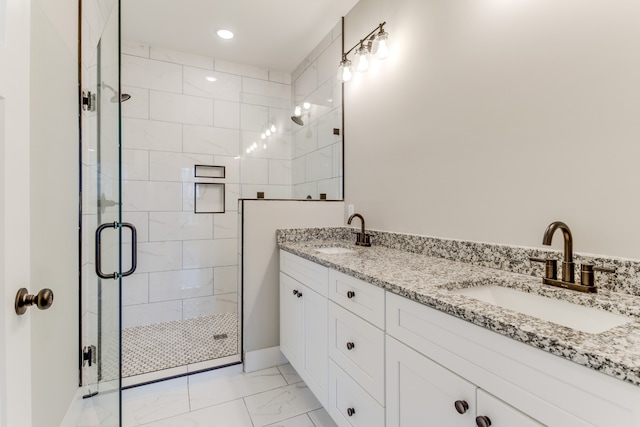 bathroom featuring vanity and an enclosed shower