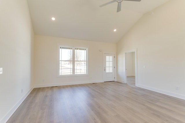 spare room with ceiling fan, light hardwood / wood-style floors, and vaulted ceiling