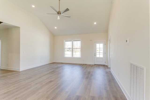 unfurnished living room featuring light wood-type flooring, ceiling fan, and high vaulted ceiling