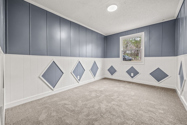 carpeted empty room with a textured ceiling