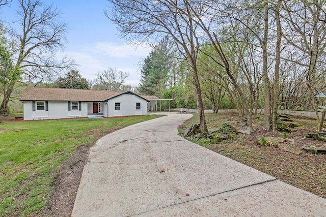 ranch-style house with a carport and a front lawn