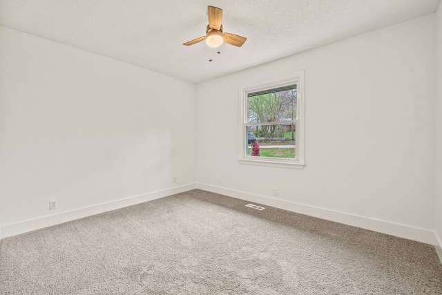 empty room featuring a textured ceiling, carpet flooring, and ceiling fan