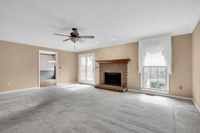 unfurnished living room with a brick fireplace, a textured ceiling, light carpet, ornamental molding, and ceiling fan