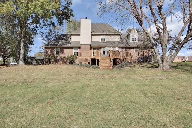 back of property with a wooden deck and a yard