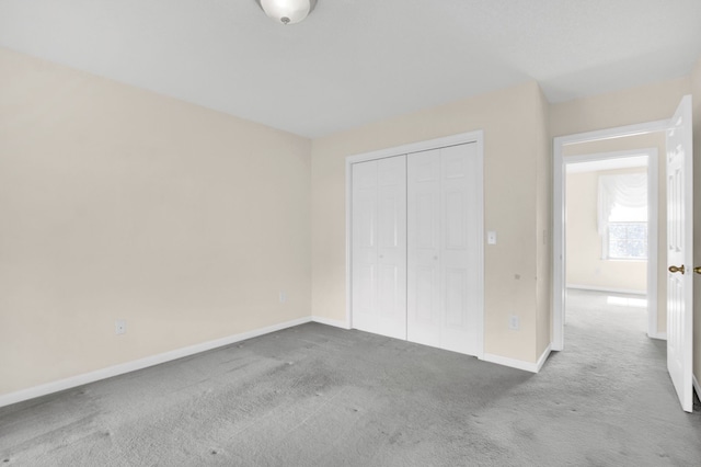 unfurnished bedroom with carpet flooring and a closet