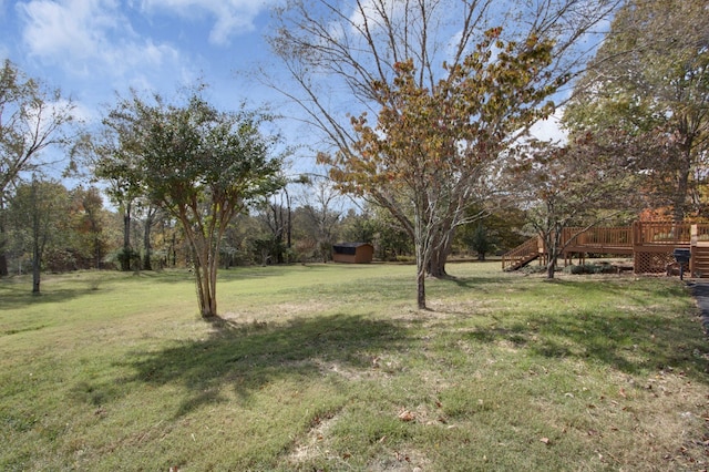 view of yard with a storage unit and a wooden deck