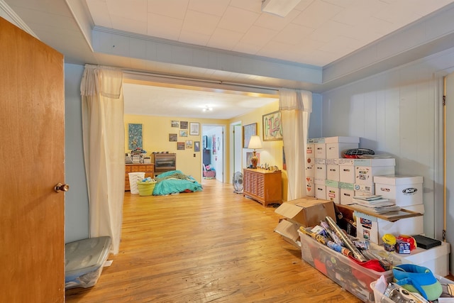 hallway with light hardwood / wood-style flooring and crown molding