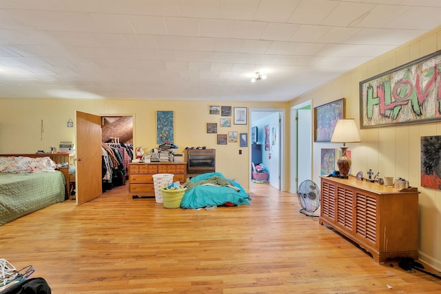 bedroom with light hardwood / wood-style floors and a closet