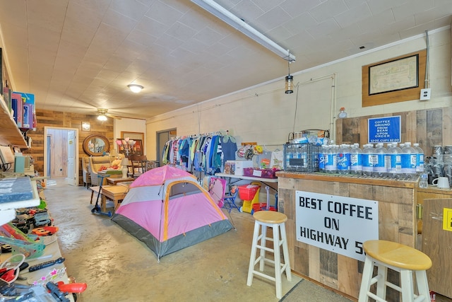 interior space featuring wooden walls and ceiling fan