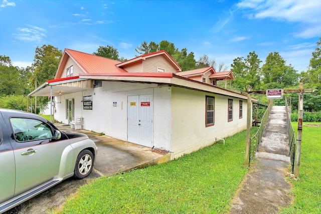 view of side of home with a yard