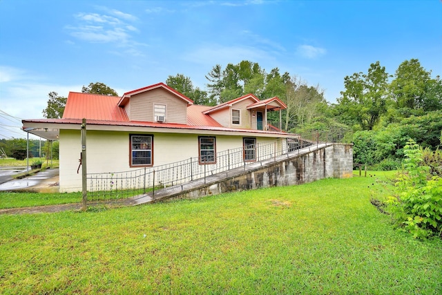 rear view of property with a lawn