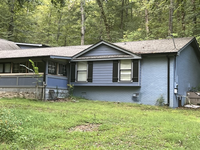 view of side of home featuring a yard