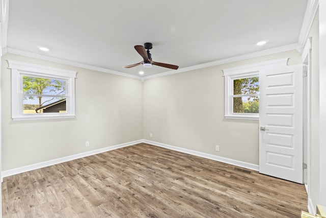 spare room with ornamental molding, hardwood / wood-style flooring, and a healthy amount of sunlight