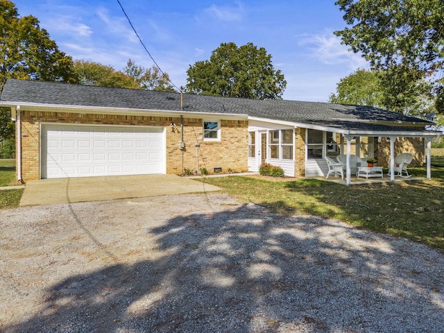 ranch-style home with a garage and a front yard