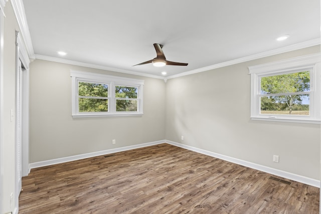 unfurnished room featuring dark wood-type flooring, ceiling fan, and crown molding