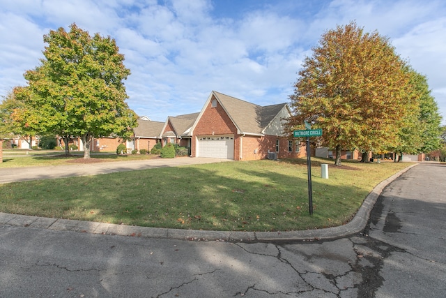 view of front facade with a front yard and a garage