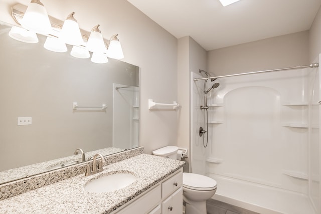 bathroom featuring tile patterned floors, a shower, vanity, and toilet