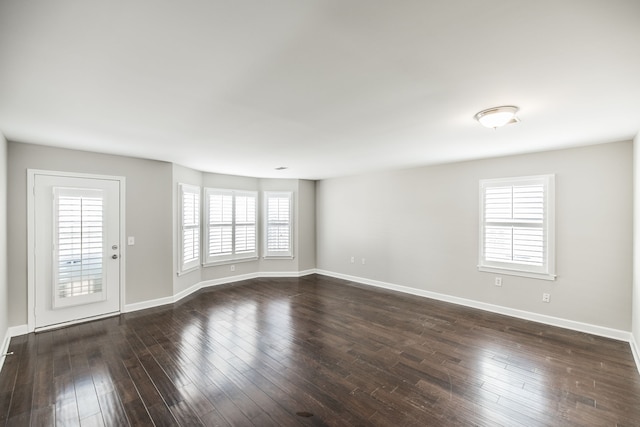 unfurnished room with dark hardwood / wood-style floors