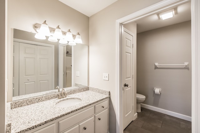 bathroom featuring vanity, wood-type flooring, and toilet