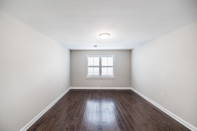 unfurnished room featuring dark wood-type flooring