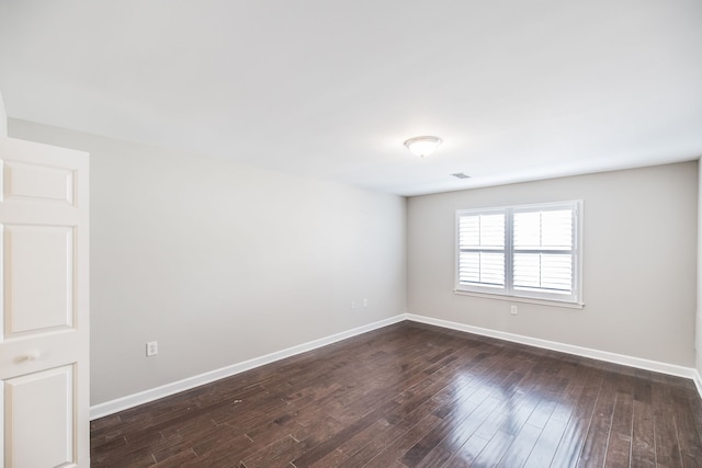 spare room featuring dark hardwood / wood-style floors