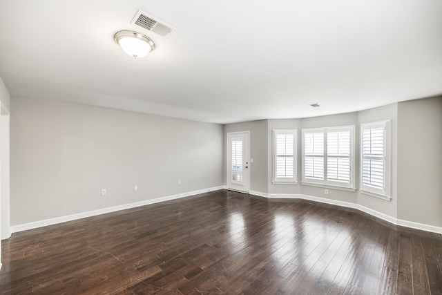 spare room with dark hardwood / wood-style flooring