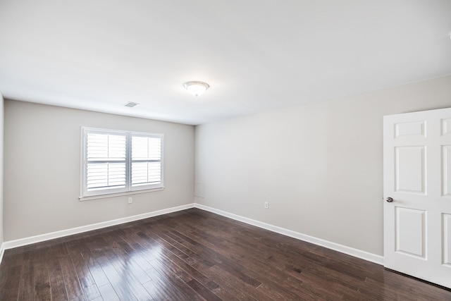 spare room featuring dark hardwood / wood-style floors