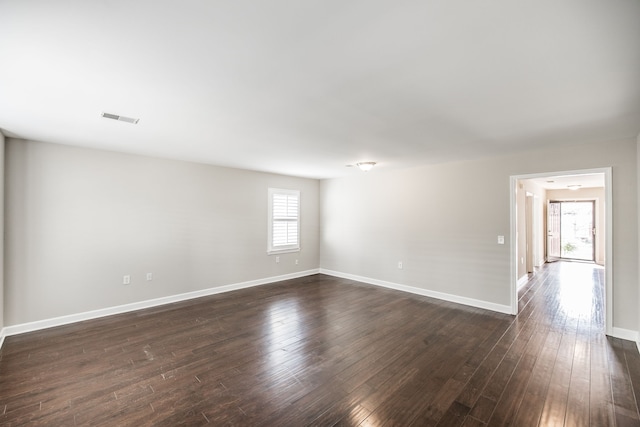 unfurnished room featuring dark wood-type flooring