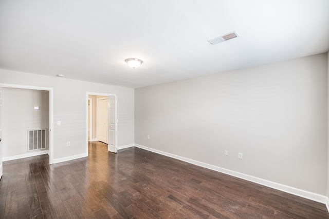 spare room featuring dark hardwood / wood-style floors