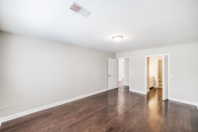 empty room featuring dark hardwood / wood-style flooring