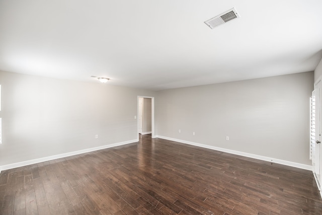 unfurnished room featuring dark wood-type flooring