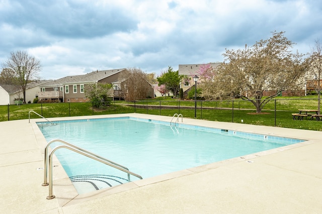 view of pool with a yard